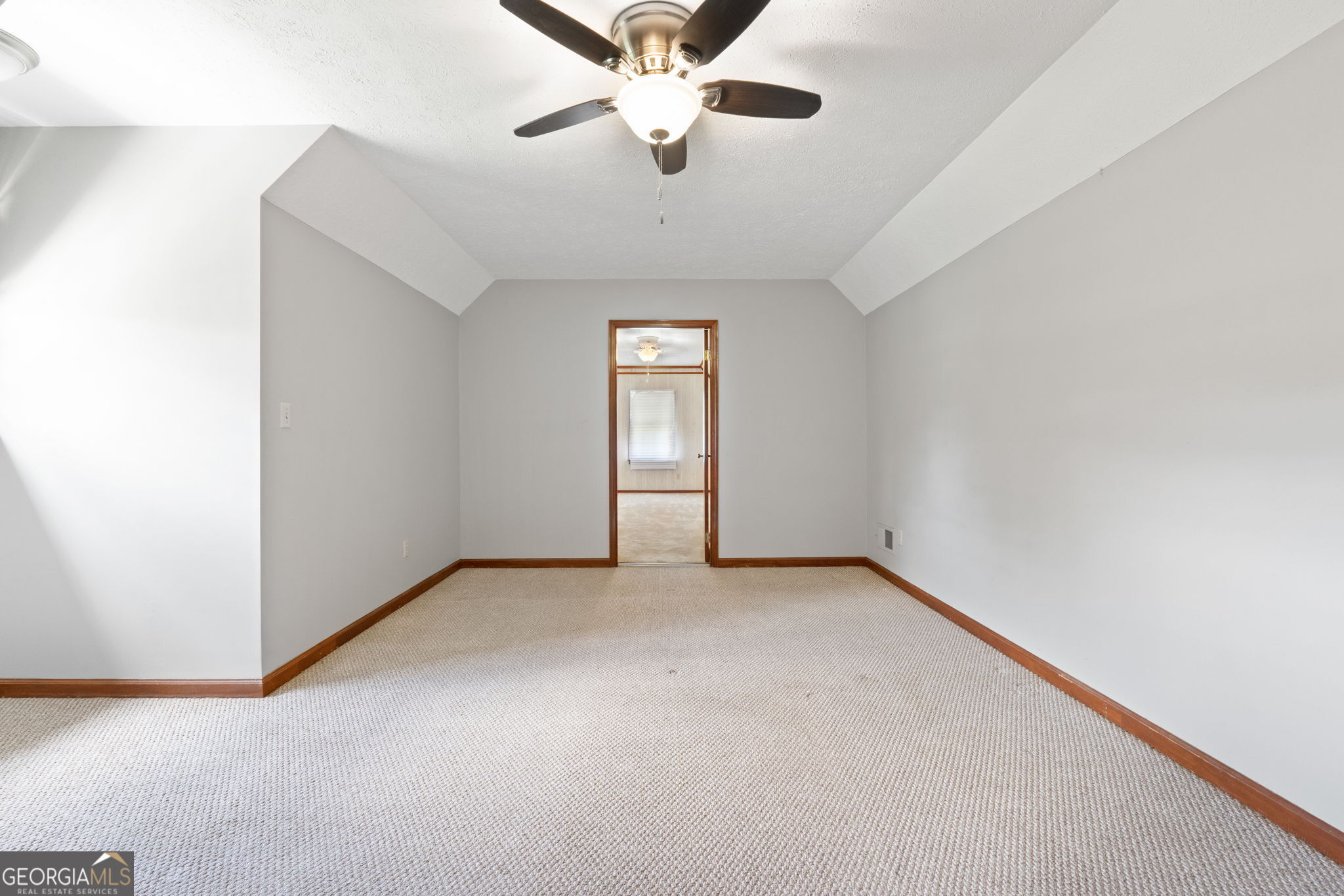 2050 North McDonough Road Griffin, GA 30223 - Photo 21 of 42 an empty room with chandelier fan and windows