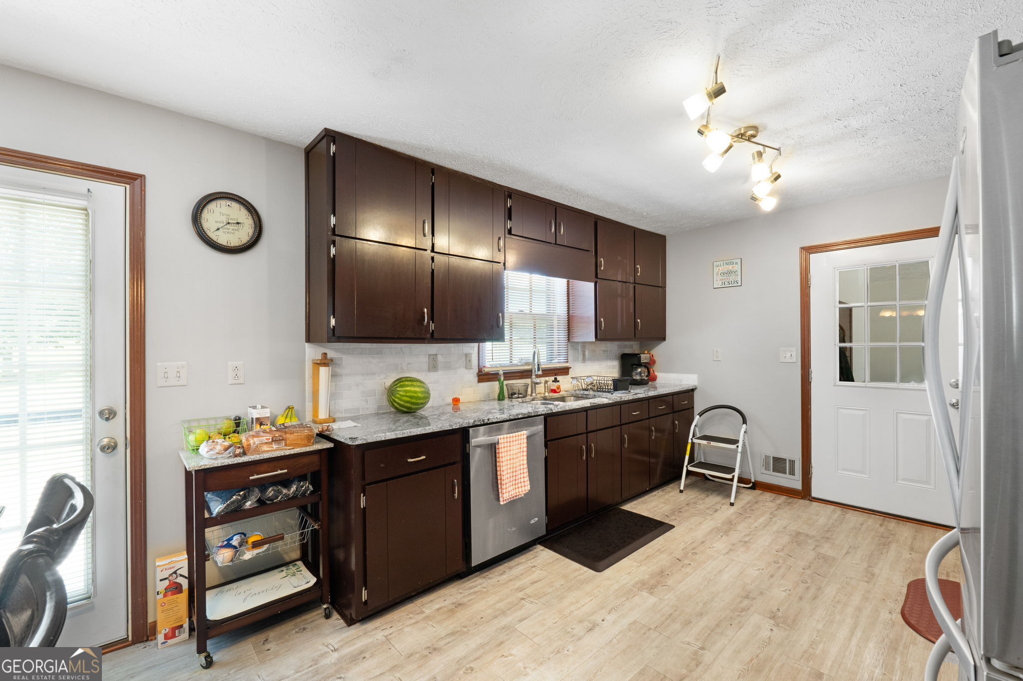 2050 North McDonough Road Griffin, GA 30223 - Photo 9 of 42 a kitchen with stainless steel appliances kitchen island granite countertop a sink and cabinets