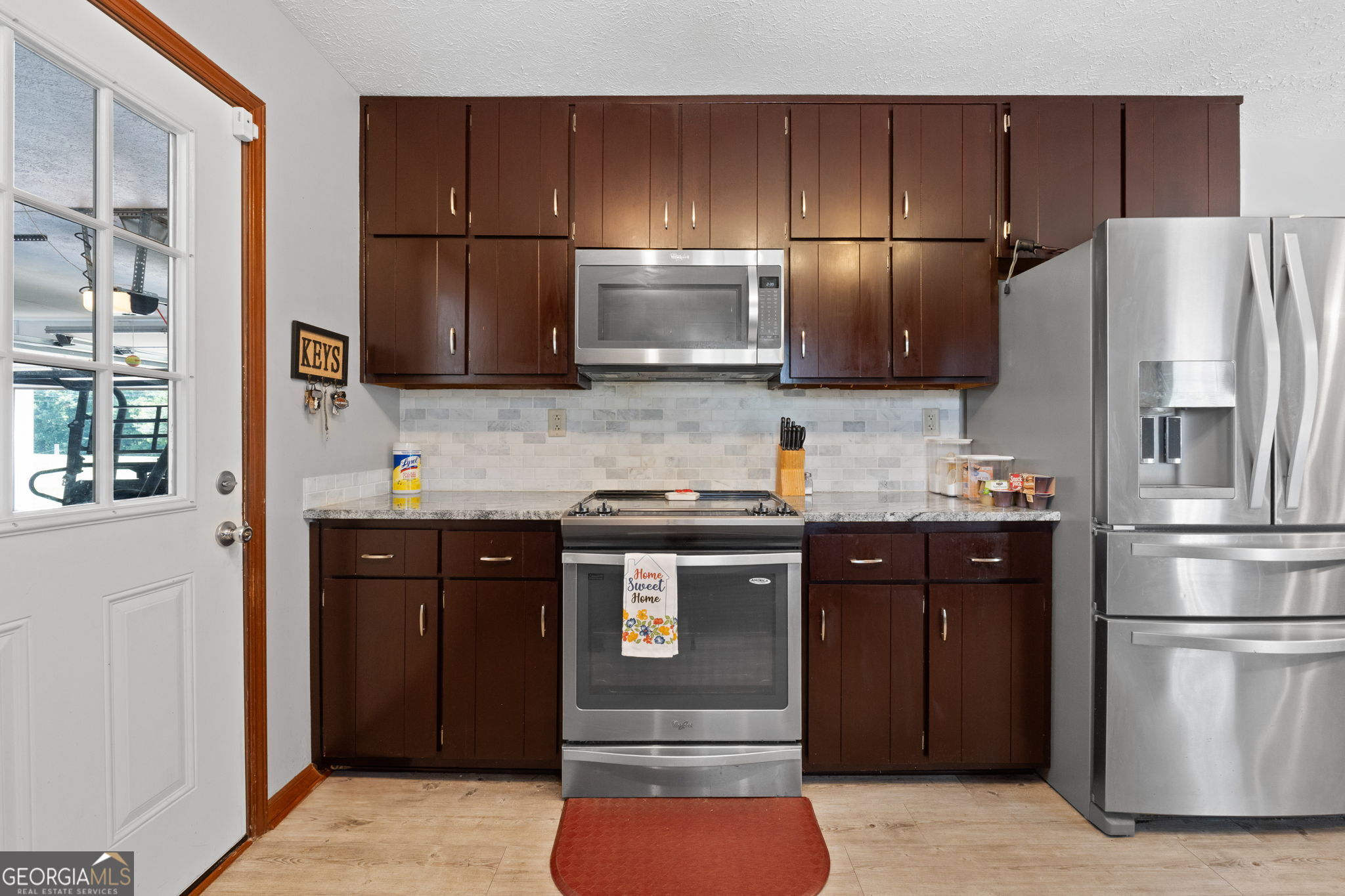 2050 North McDonough Road Griffin, GA 30223 - Photo 10 of 42 a kitchen with stainless steel appliances granite countertop a refrigerator and a sink
