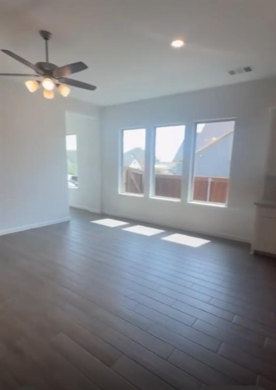3121 Winecup Way Little Elm, TX 75068 - Photo 11 of 23 an empty room with wooden floor and windows