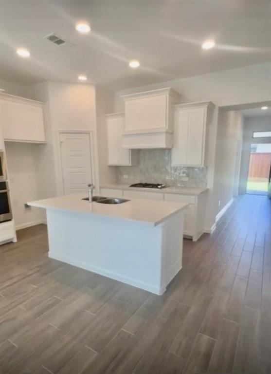 3121 Winecup Way Little Elm, TX 75068 - Photo 12 of 23 a large kitchen with kitchen island a sink stainless steel appliances and cabinets