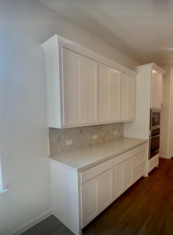3121 Winecup Way Little Elm, TX 75068 - Photo 7 of 23 a view of cabinets with wooden floor