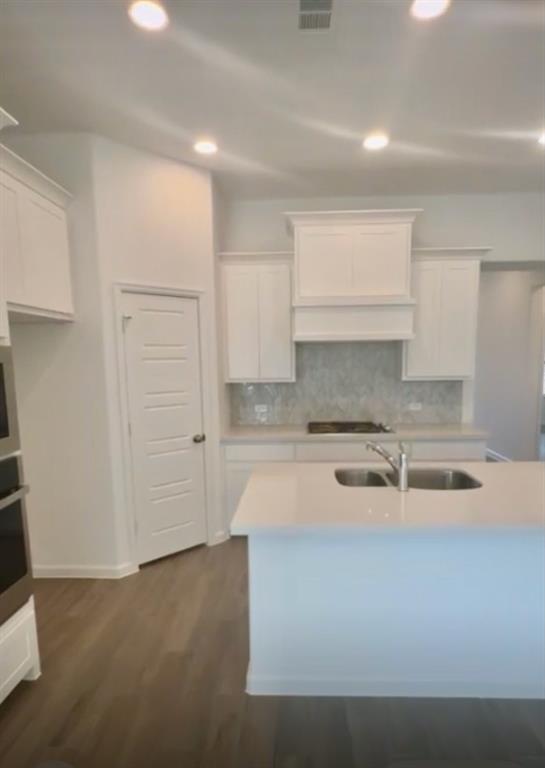 3121 Winecup Way Little Elm, TX 75068 - Photo 8 of 23 a kitchen with a stove and white cabinets