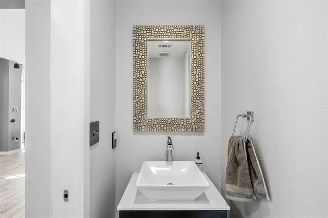 a bathroom with a sink a mirror and vanity