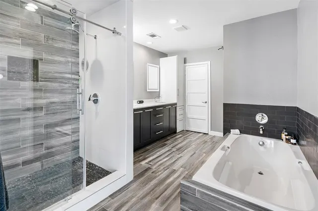 a bathroom with a tub sink and shower