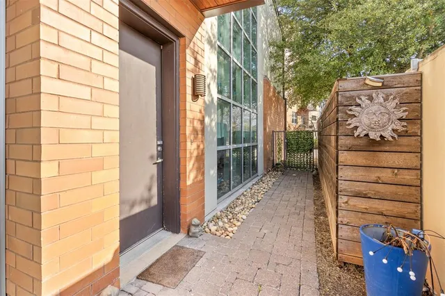 a view of a wooden door with a bench