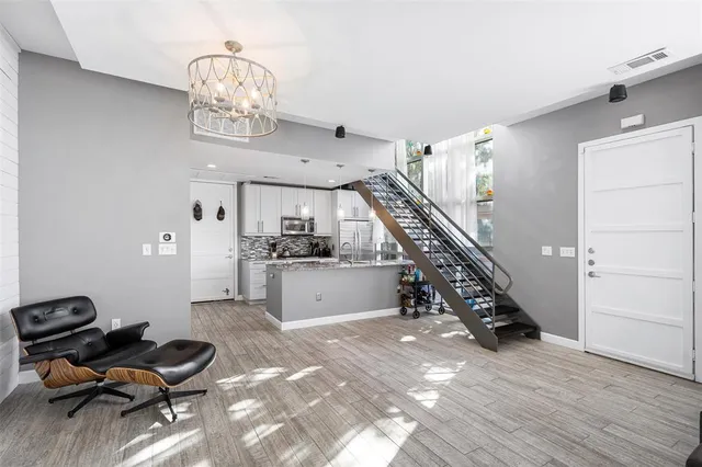 a view of a livingroom with furniture and stairs