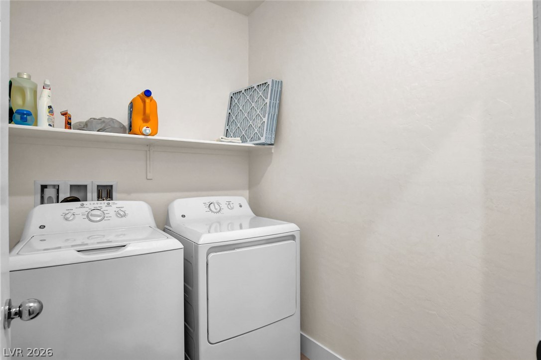 9688 Rankin Rdg Court Las Vegas, NV 89178 - Photo 40 of 53 Functional laundry space featuring a practical shelf for organization.