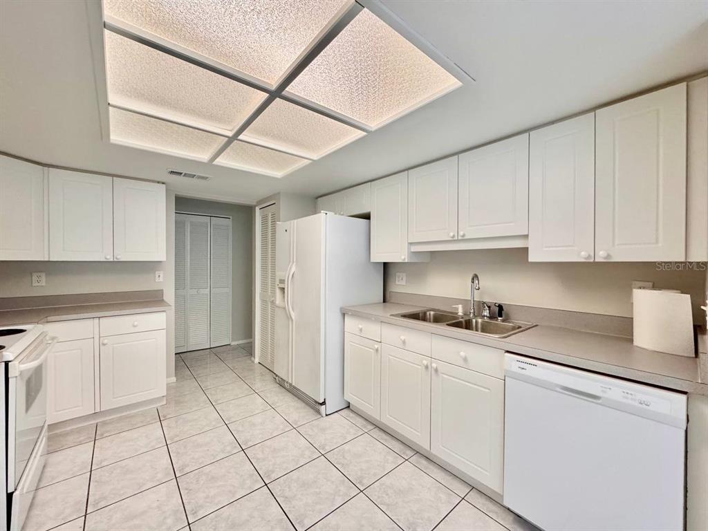 2826 Rampart Circle Clearwater, FL 33761 - Photo 11 of 30 a kitchen with granite countertop cabinets and steel stainless steel appliances