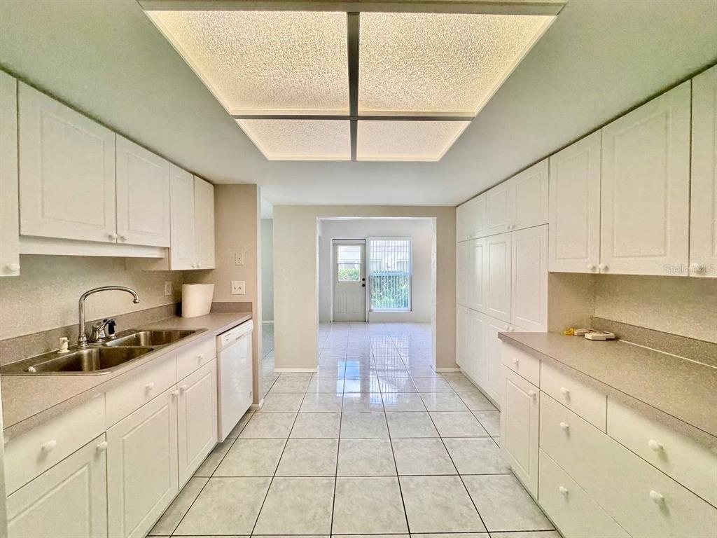 2826 Rampart Circle Clearwater, FL 33761 - Photo 12 of 30 a kitchen with stainless steel appliances granite countertop a sink a stove and cabinets