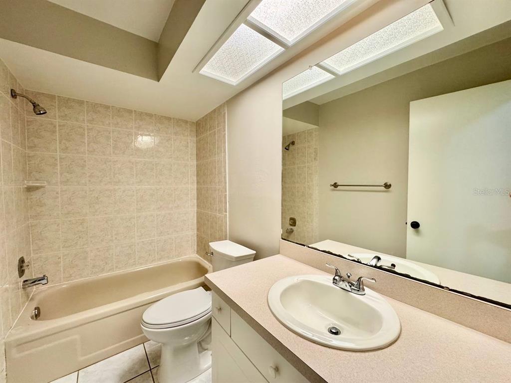 2826 Rampart Circle Clearwater, FL 33761 - Photo 16 of 30 a bathroom with a sink a toilet and shower
