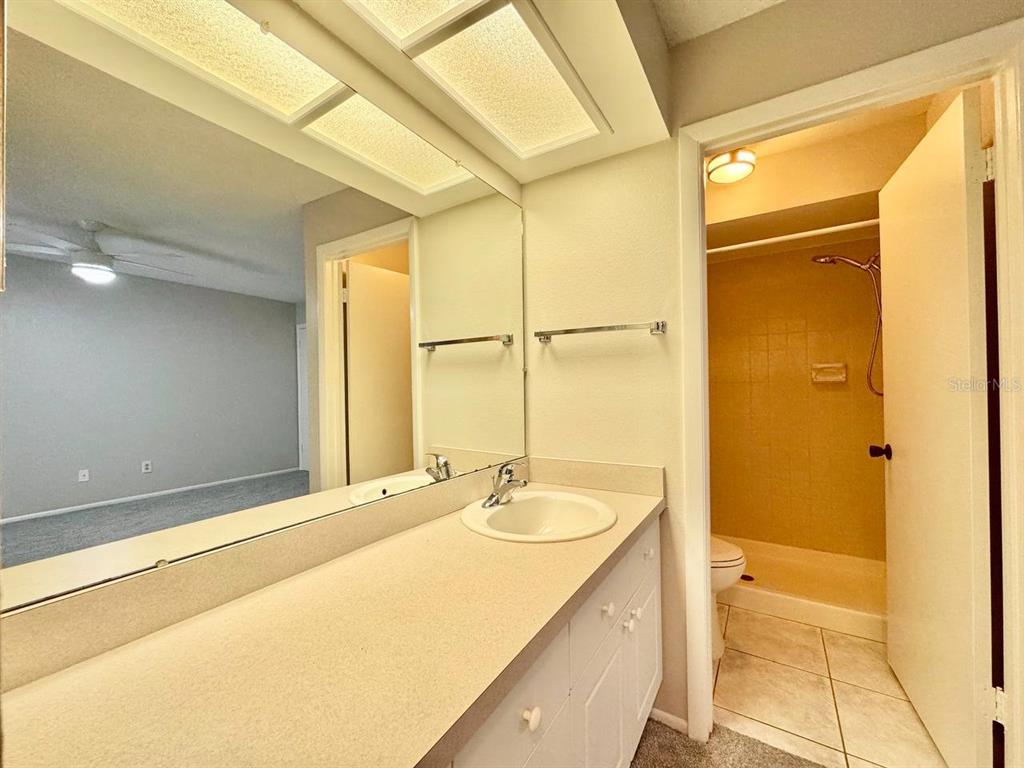 2826 Rampart Circle Clearwater, FL 33761 - Photo 24 of 30 a bathroom with a granite countertop sink and a bathtub