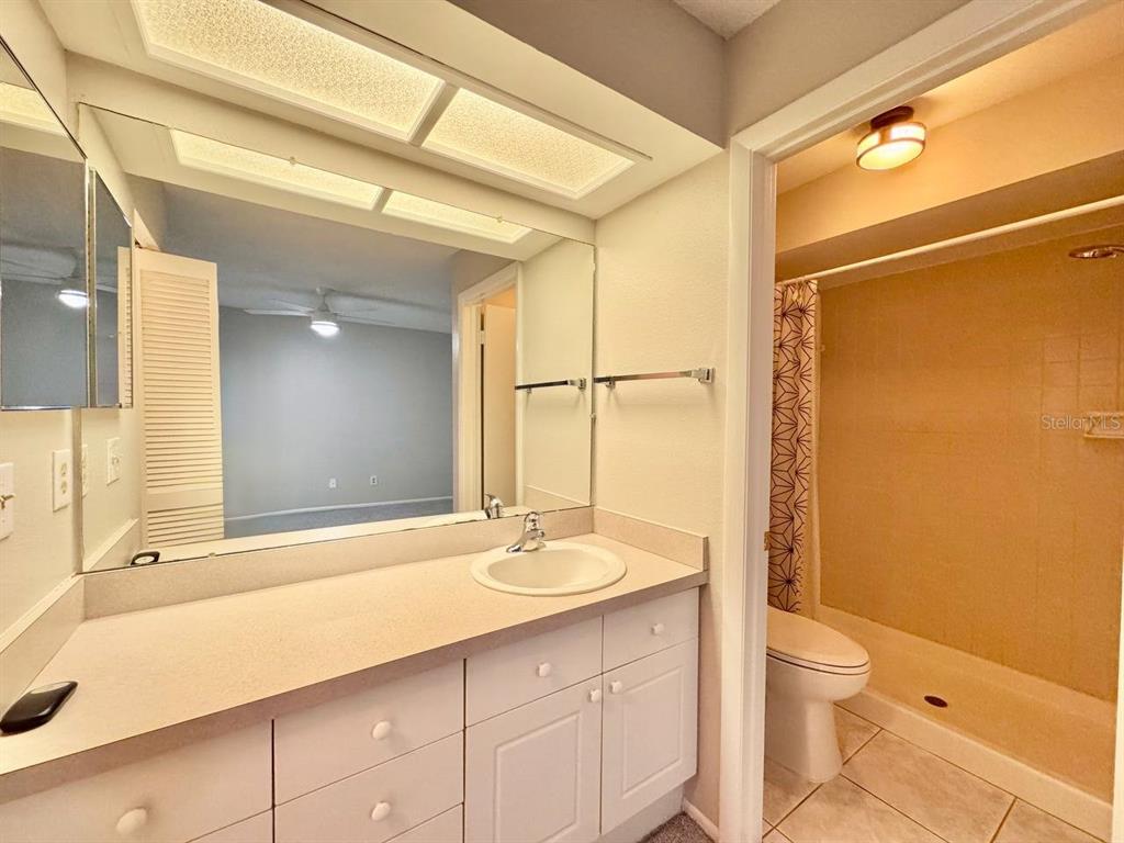 2826 Rampart Circle Clearwater, FL 33761 - Photo 27 of 30 a bathroom with a sink a toilet and shower