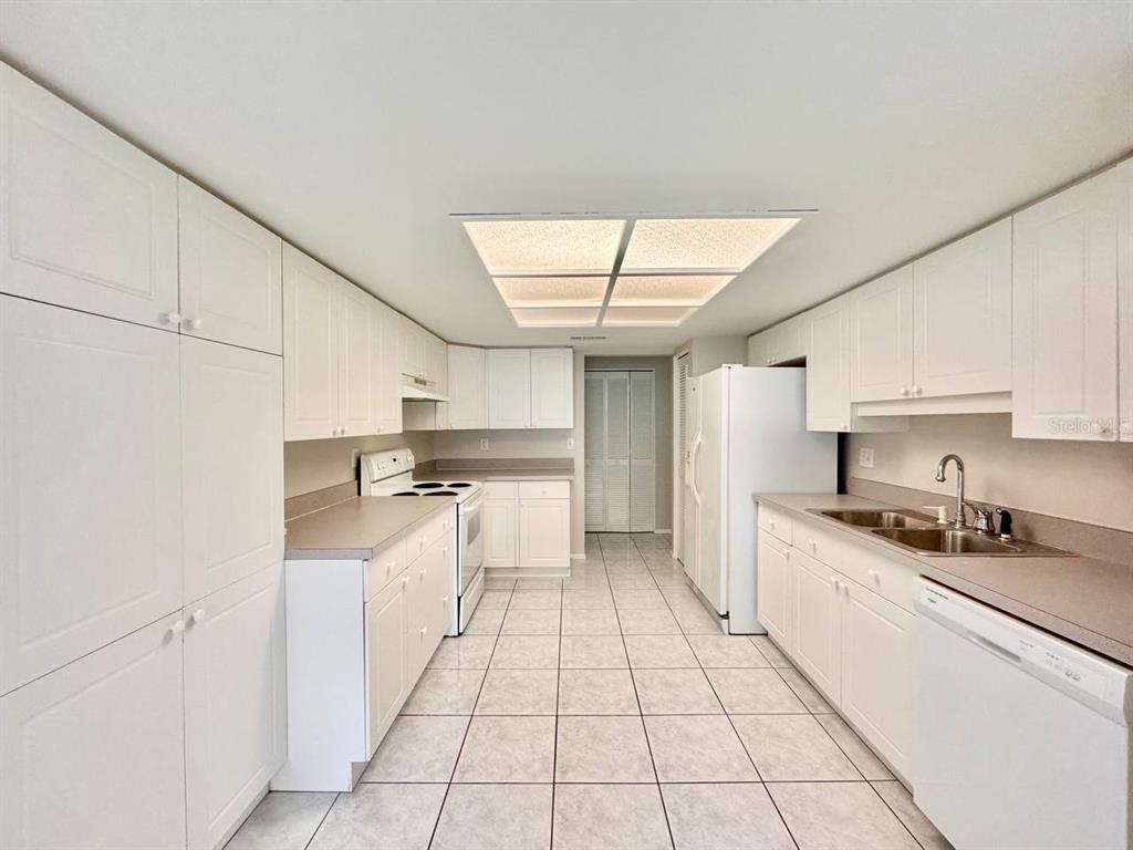 2826 Rampart Circle Clearwater, FL 33761 - Photo 9 of 30 a kitchen with stainless steel appliances granite countertop a sink and cabinets