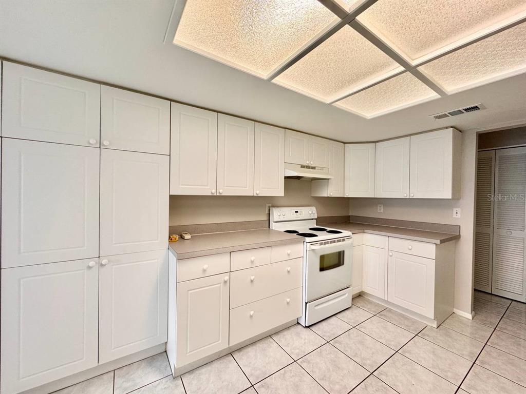 2826 Rampart Circle Clearwater, FL 33761 - Photo 10 of 30 a kitchen with white cabinets and white appliances