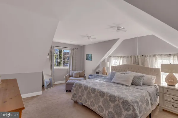 a bedroom with a bed and lamp