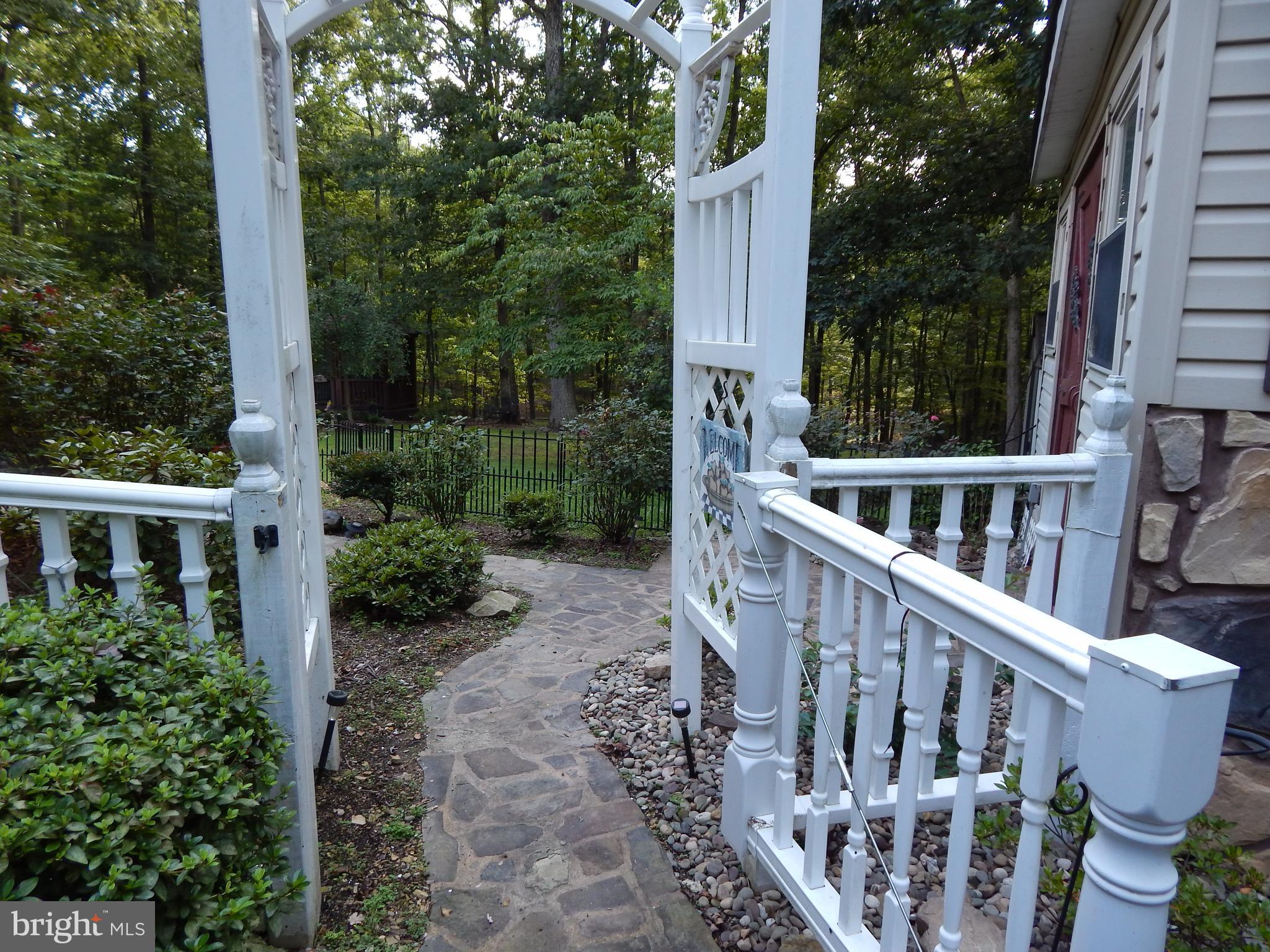 1090 Co Rte 9/8 Berkeley Springs, WV 25411 - Photo 15 of 30 Stone path to back yard