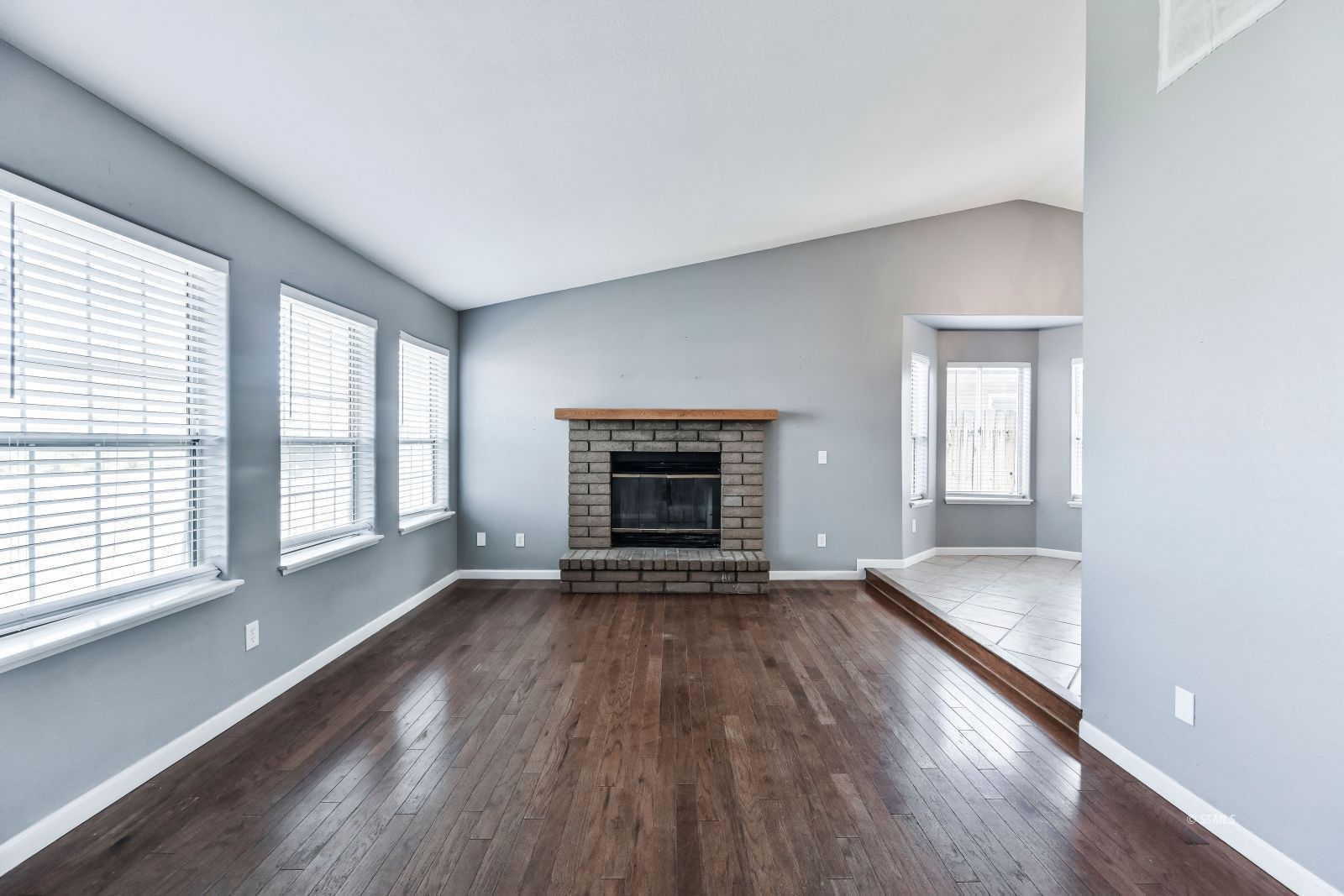 633 East Church Avenue Ridgecrest, CA 93555 - Photo 4 of 27 a view of an empty room with wooden floor and a window