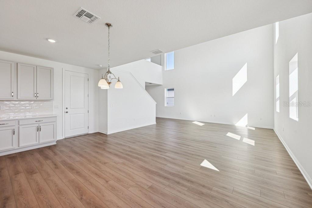 30121 Misty Pnes Road Mount Dora, FL 32757 - Photo 12 of 55 a view of an empty room with window and wooden floor