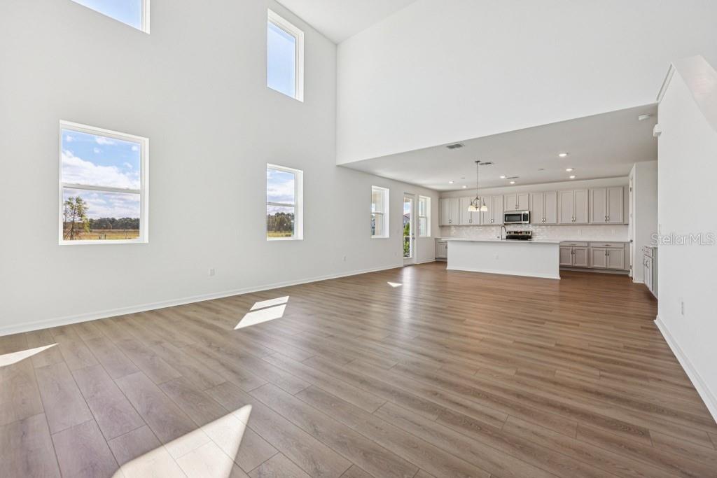 30121 Misty Pnes Road Mount Dora, FL 32757 - Photo 15 of 55 a view of an empty room with wooden floor and a window