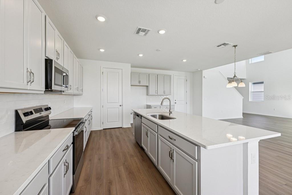 30121 Misty Pnes Road Mount Dora, FL 32757 - Photo 23 of 55 a kitchen with a sink stove and cabinets