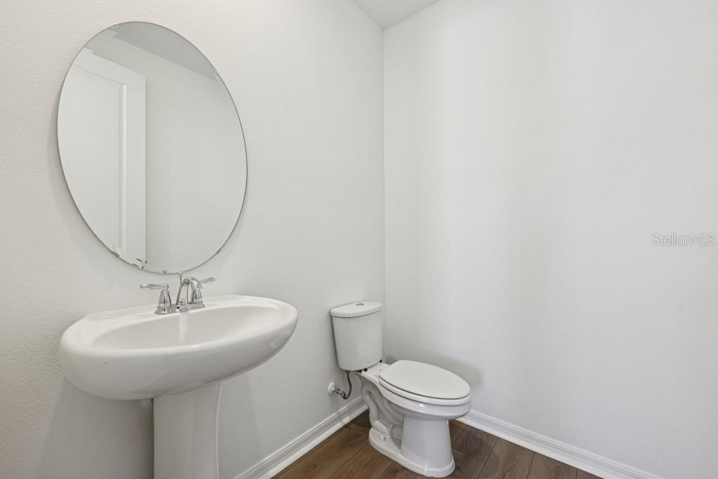 30121 Misty Pnes Road Mount Dora, FL 32757 - Photo 30 of 55 a bathroom with a sink a toilet and a mirror