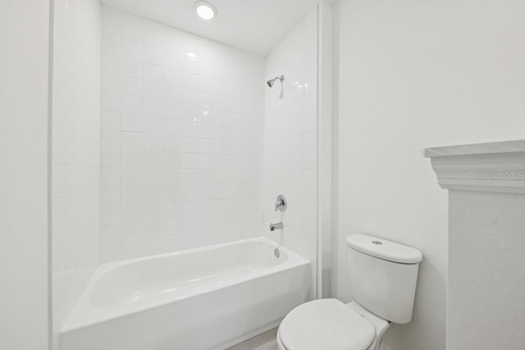 30121 Misty Pnes Road Mount Dora, FL 32757 - Photo 46 of 55 a white toilet sitting next to a bath tub