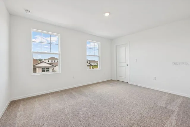 front view of a house with a flower garden