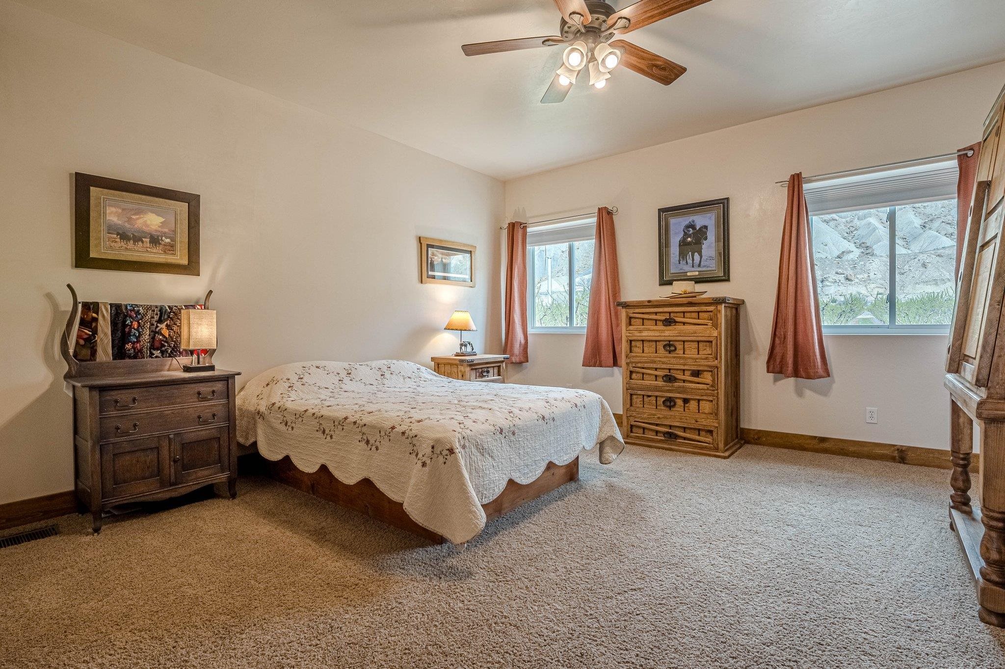 3652 1/2 G 7/10 Road Palisade, CO 81526 - Photo 24 of 42 a bedroom with a bed and a chandelier