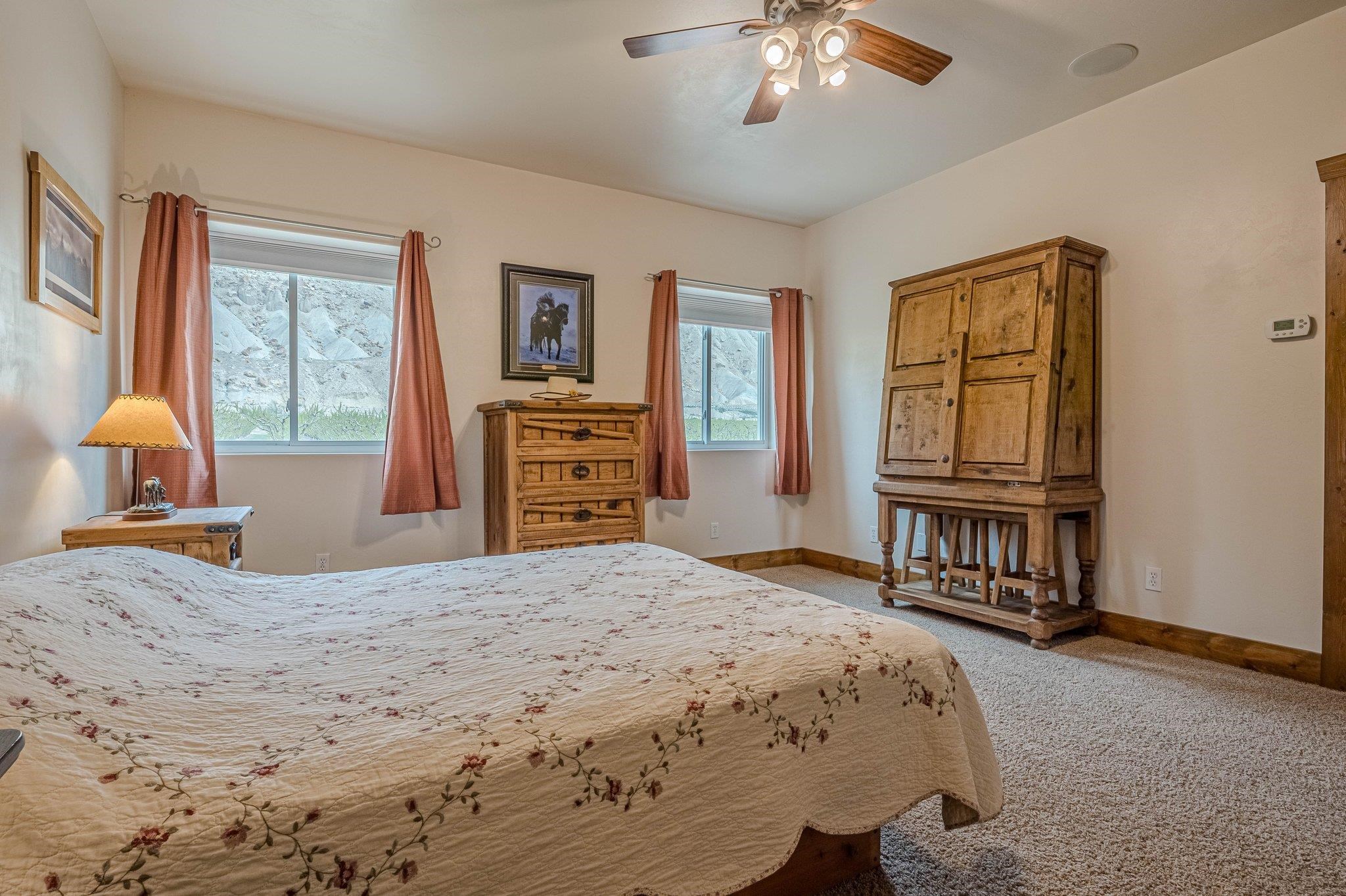 3652 1/2 G 7/10 Road Palisade, CO 81526 - Photo 25 of 42 a bedroom with a bed dresser and a window
