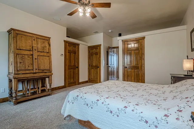 a spacious bedroom with a bed and a lamp