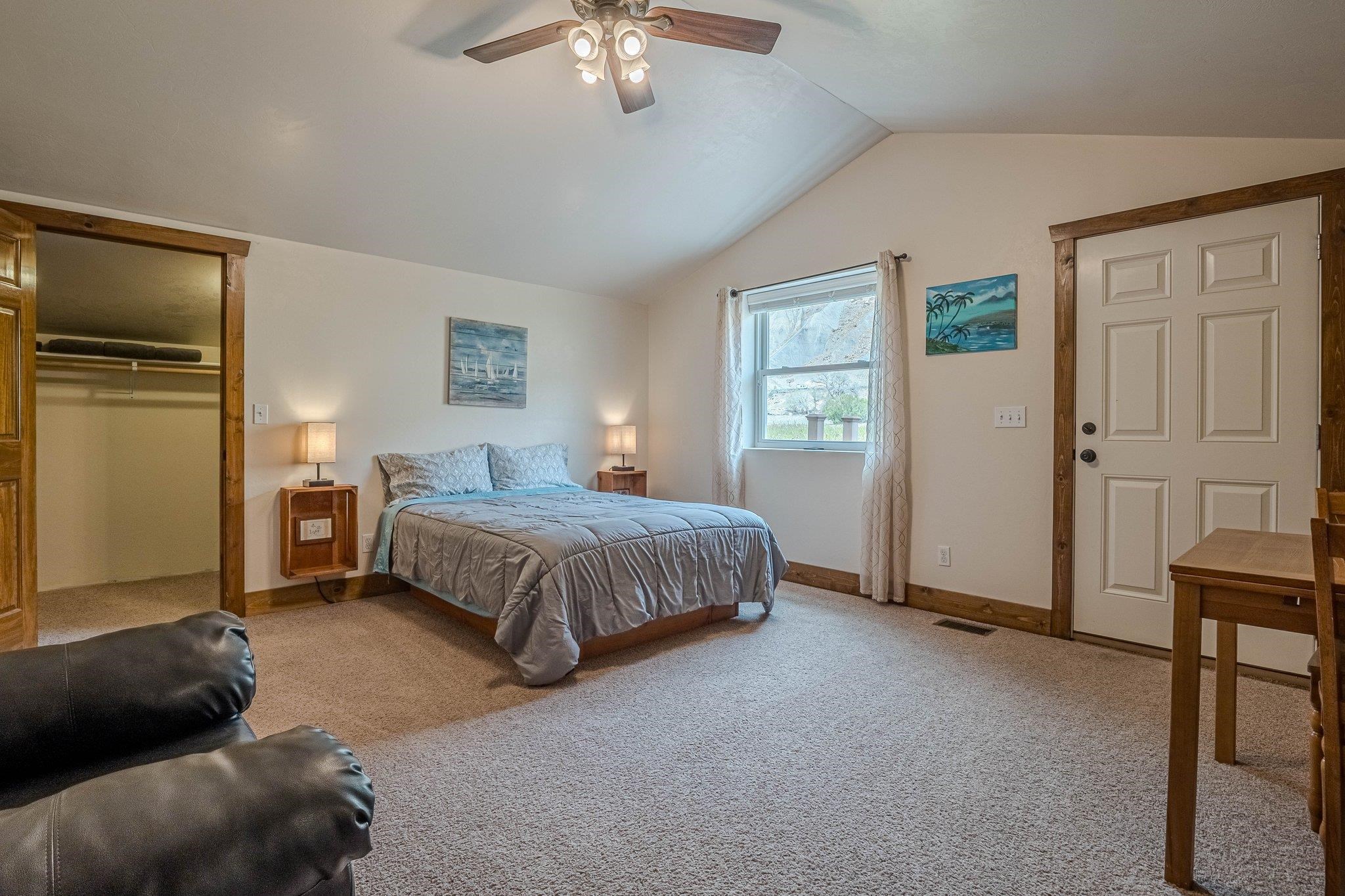 3652 1/2 G 7/10 Road Palisade, CO 81526 - Photo 40 of 42 a bedroom with a bed and a chandelier