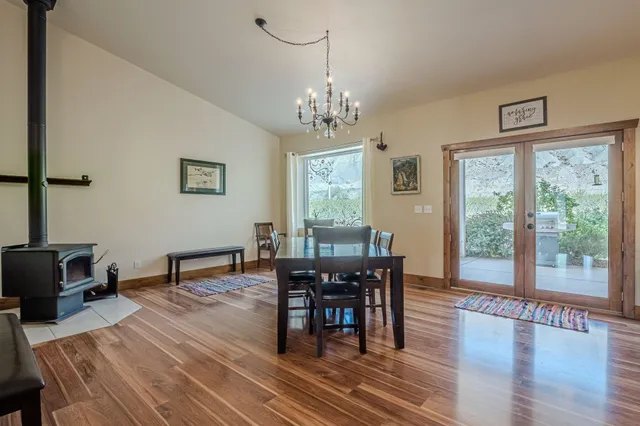 a view of a dining room with furniture and chandelier