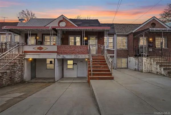 a front view of a house with wooden fence