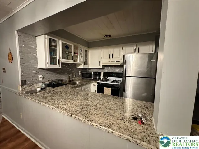 a kitchen with a sink and a refrigerator
