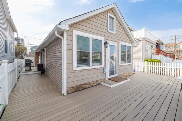 a view of a house with a wooden deck