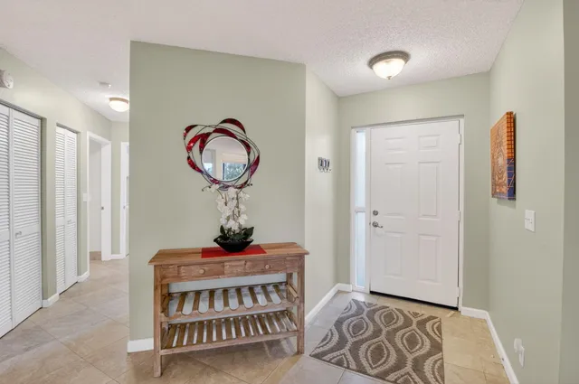 a living room with furniture and a lamp
