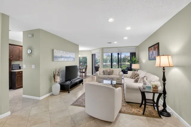 a living room with furniture and a lamp