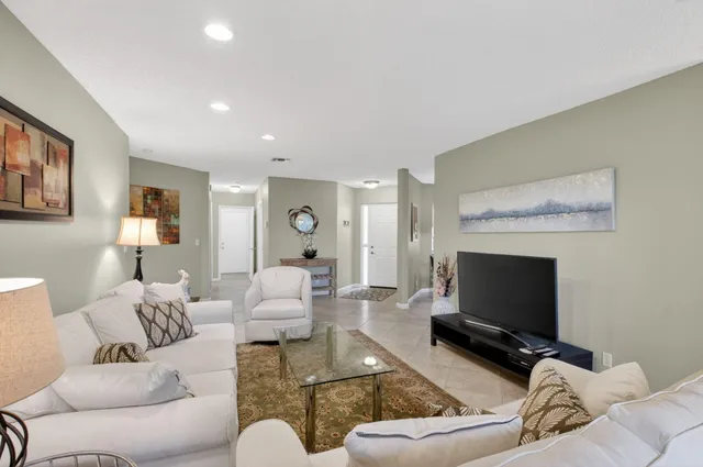 a dining room with furniture a chandelier and window