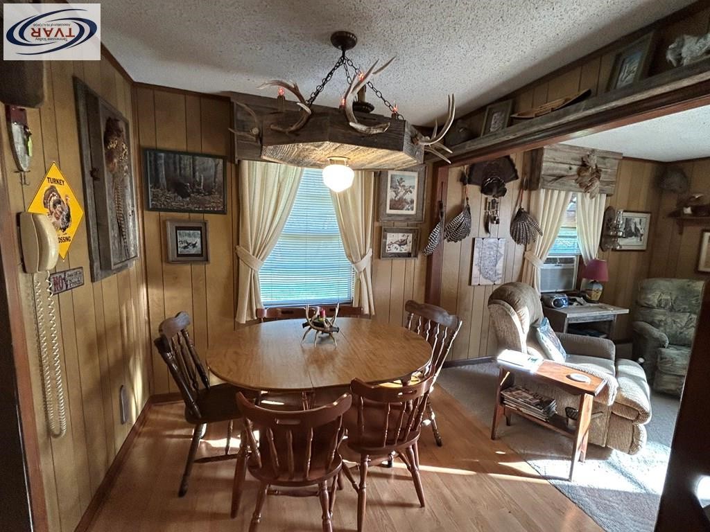 4460 Point Mason Road Big Sandy, TN 38221 - Photo 11 of 22 a dining room with furniture a chandelier and window