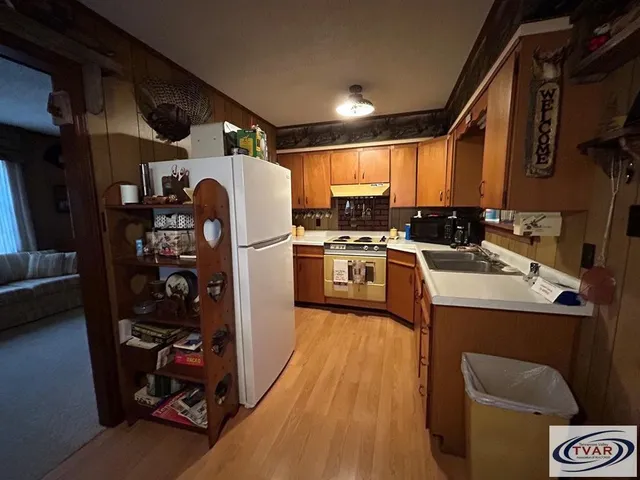 a kitchen with a sink a stove and a refrigerator