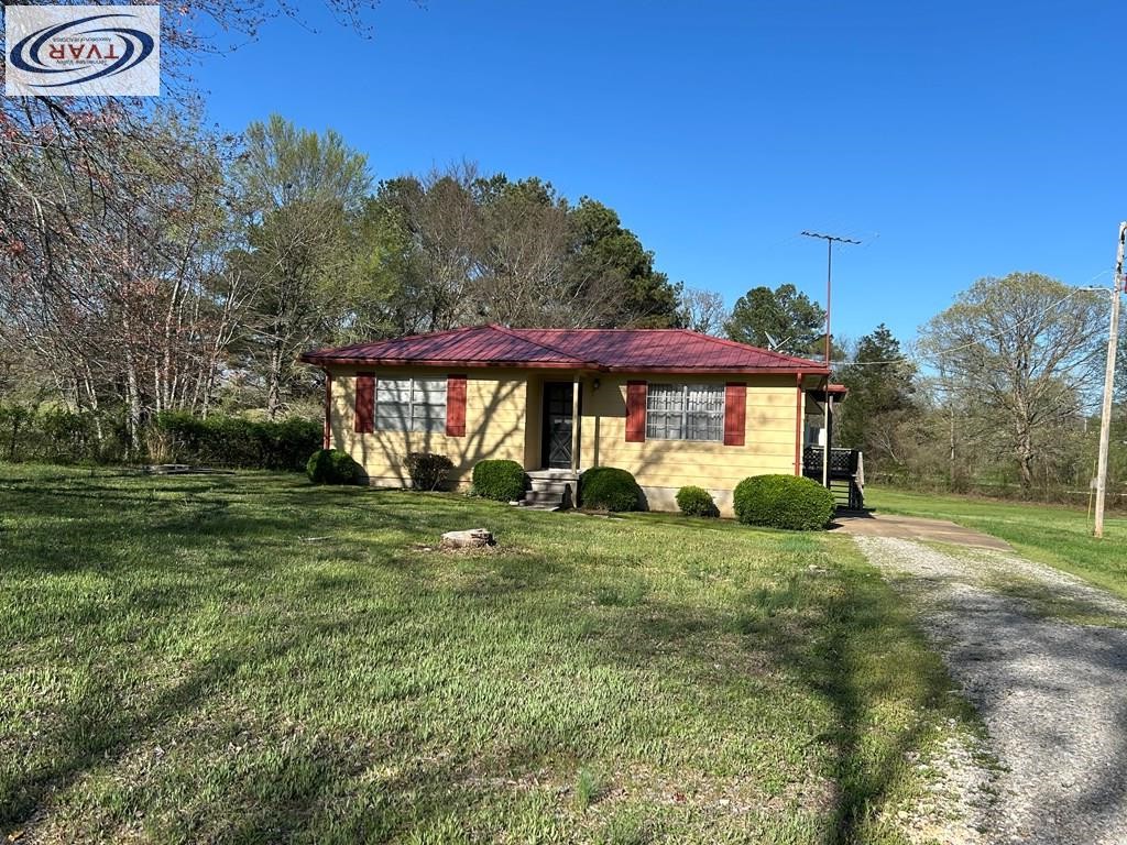4460 Point Mason Road Big Sandy, TN 38221 - Photo 2 of 22 a view of a house with a yard