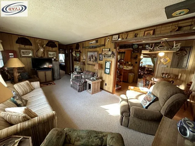 a living room with furniture and a gym machine