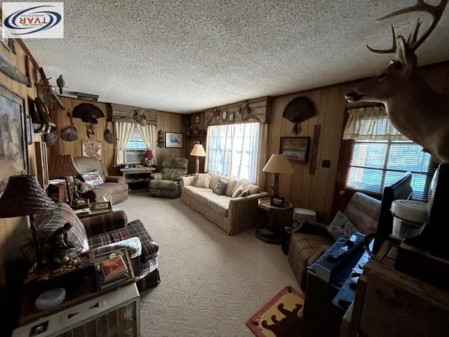 a living room with furniture a window and gym equipment