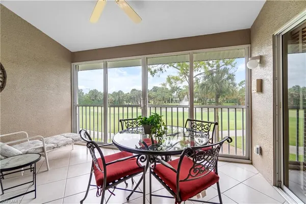 a dining room with furniture water view and a large window