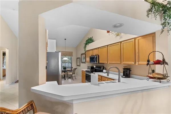 a kitchen with stainless steel appliances a sink a stove and a refrigerator