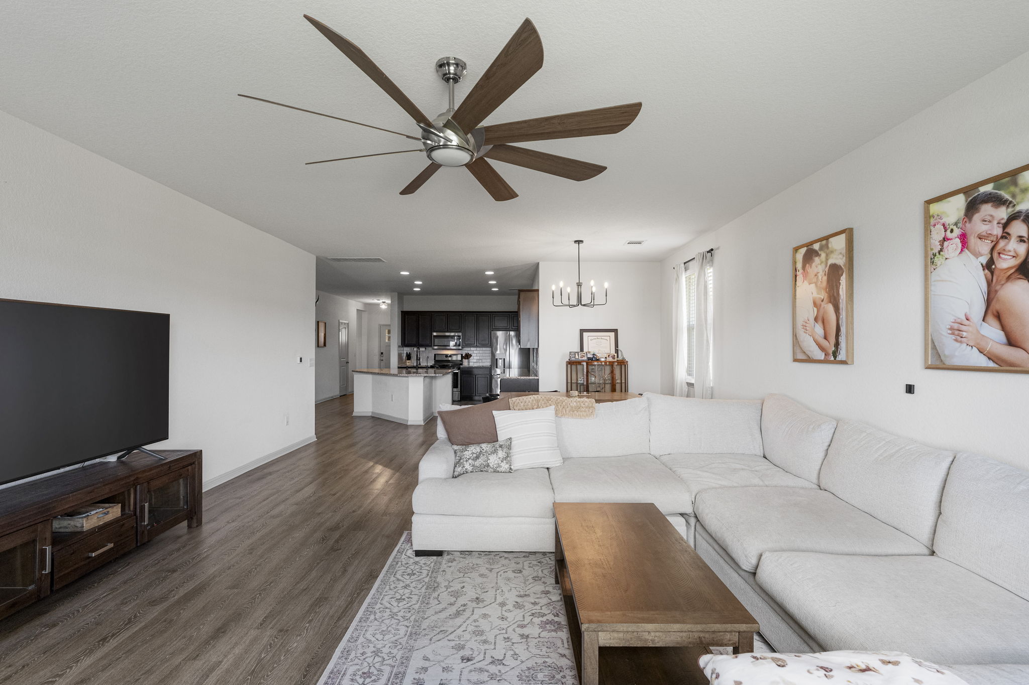 185 Struss Drive Georgetown, TX 78626 - Photo 10 of 23 An open-concept living space with a contemporary ceiling fan and durable hardwood flooring.