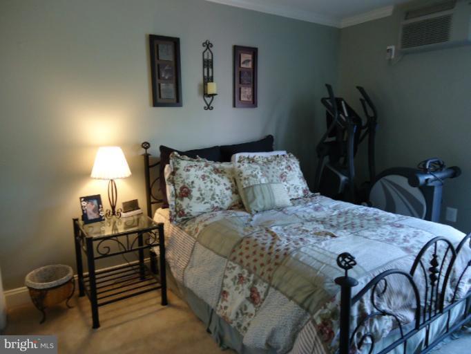501 Prospect Boulevard, Unit A25 Frederick, MD 21701 - Photo 13 of 14 a bedroom with a bed and a table in it