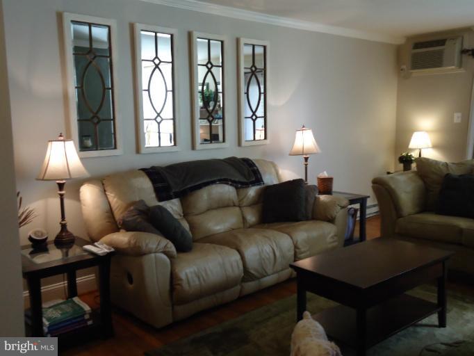 501 Prospect Boulevard, Unit A25 Frederick, MD 21701 - Photo 3 of 14 a living room with furniture and a lamp