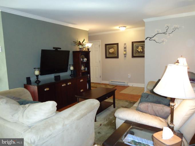 501 Prospect Boulevard, Unit A25 Frederick, MD 21701 - Photo 4 of 14 a living room with furniture and a flat screen tv